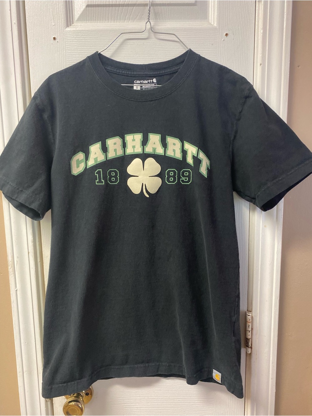 Carhartt Black Short-Sleeve Tee with Green Accent Clover. Has Light Stains